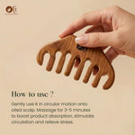 A hand holds a wooden scalp massage comb against a warm beige background, with text explaining how to use it on oiled scalp.
