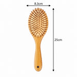 A wooden hairbrush with dimension arrows showing a width of 8.3cm and a height of 25cm on a plain white background.
