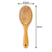 A wooden hairbrush with dimension arrows showing a width of 8.3cm and a height of 25cm on a plain white background.
